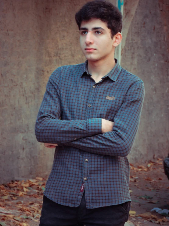 a guy posing in front of a building