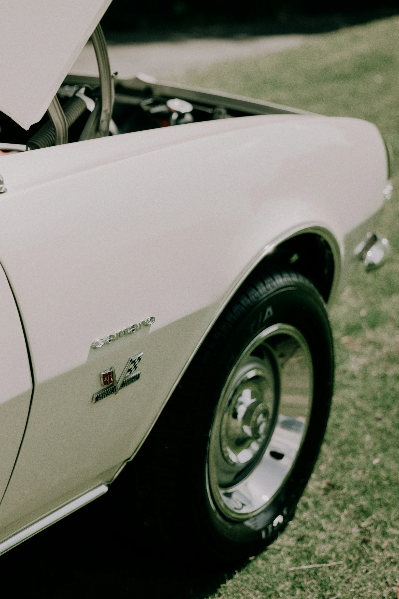 an old muscle car has a hood open