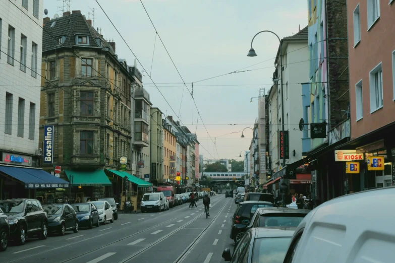 a very narrow street with lots of cars on it