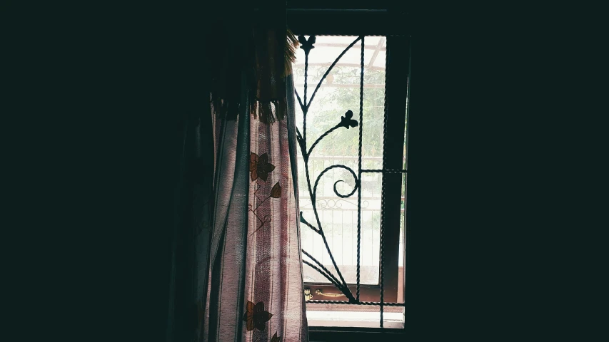 a window showing through the curtain on top of a bed