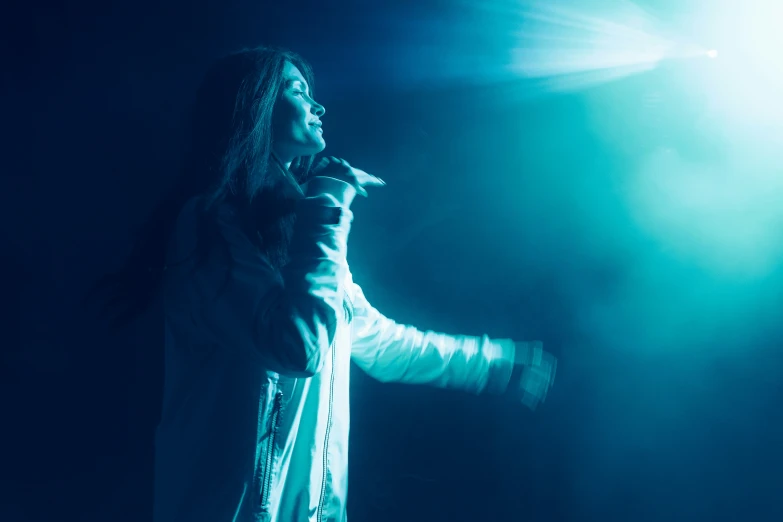 a person in a white jacket on a stage