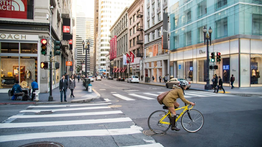 the man is riding his bicycle down the street