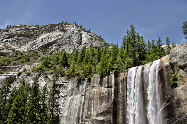 a large waterfall cascading from the side of a cliff