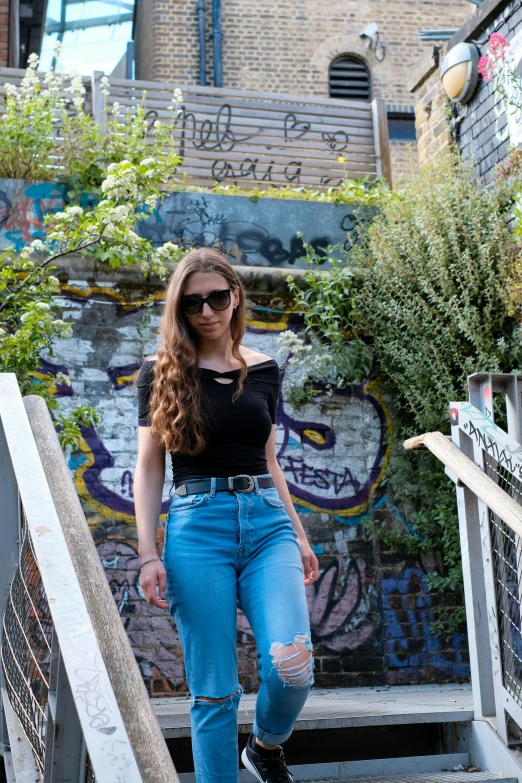 a young woman is standing on a set of stairs