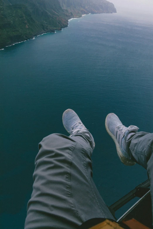 a persons legs hanging out while sitting on a boat