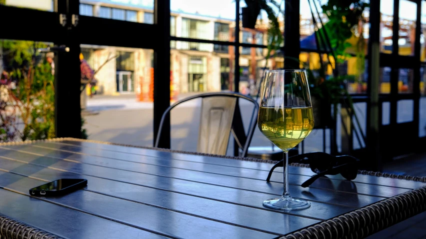 wine glasses filled with liquid sitting on top of a table