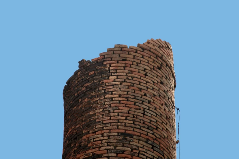 the top of an old tower with a blue sky background