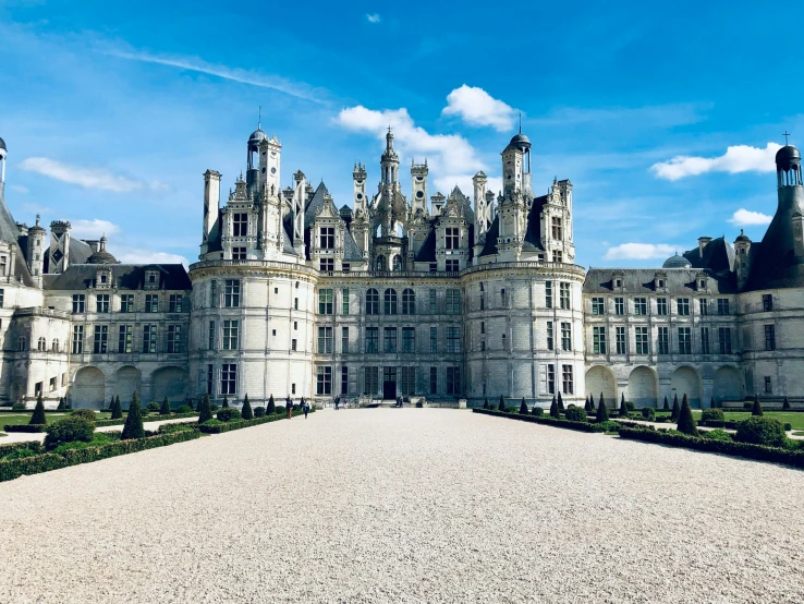 a very ornate building with large trees in front