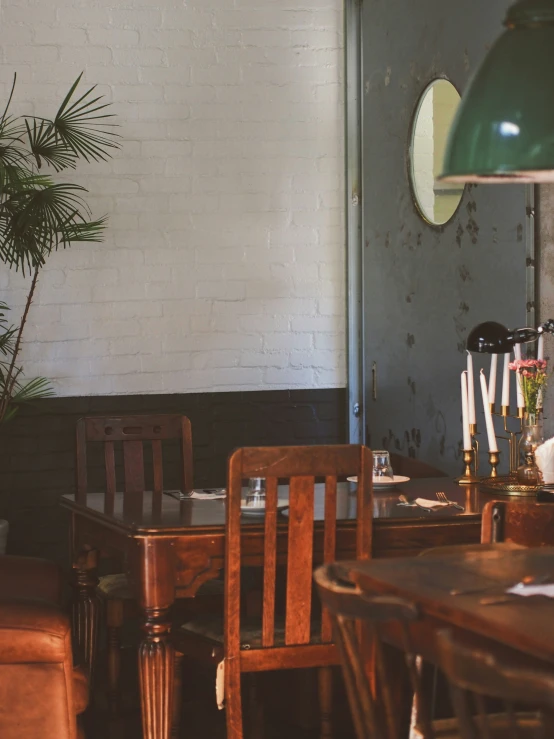 a dining room table with two brown chairs