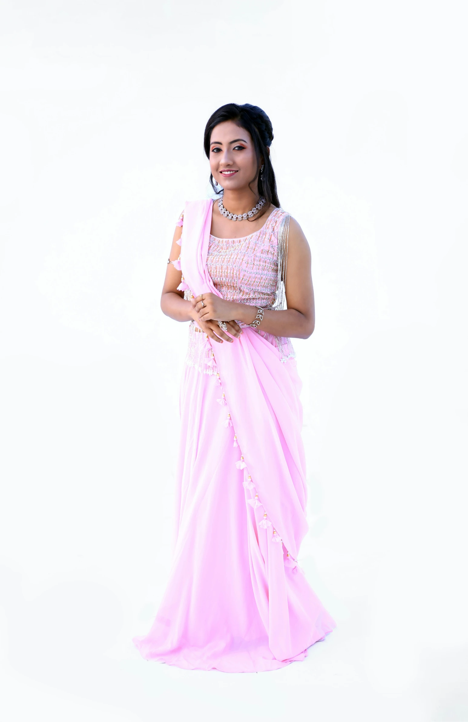 young woman in pink clothing standing smiling