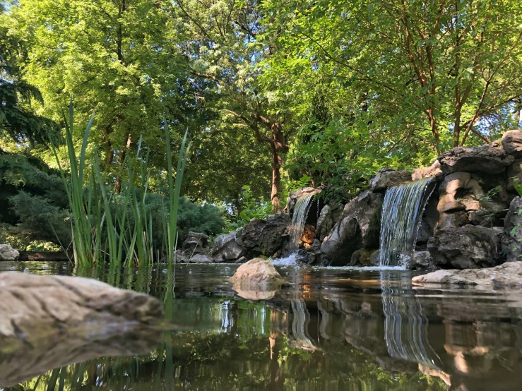 a very small body of water with a waterfall