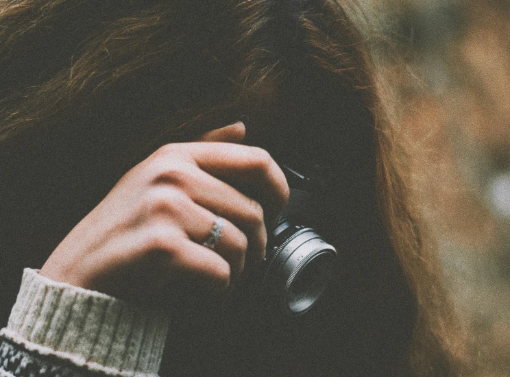 a person holding a camera up against their face