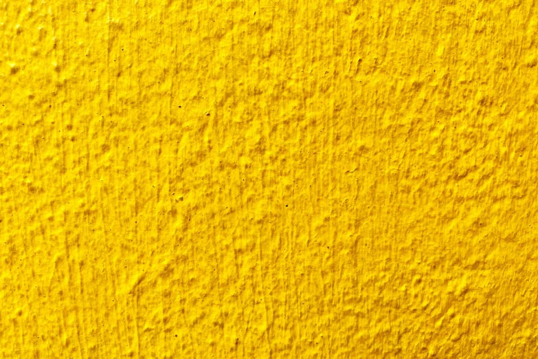 a textured yellow paint with a faded, fading stain