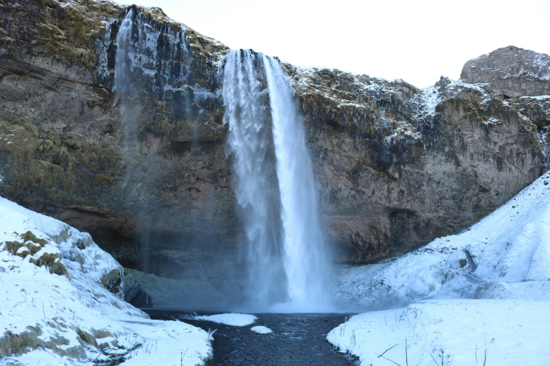 a waterfall is shown with a stream in the middle