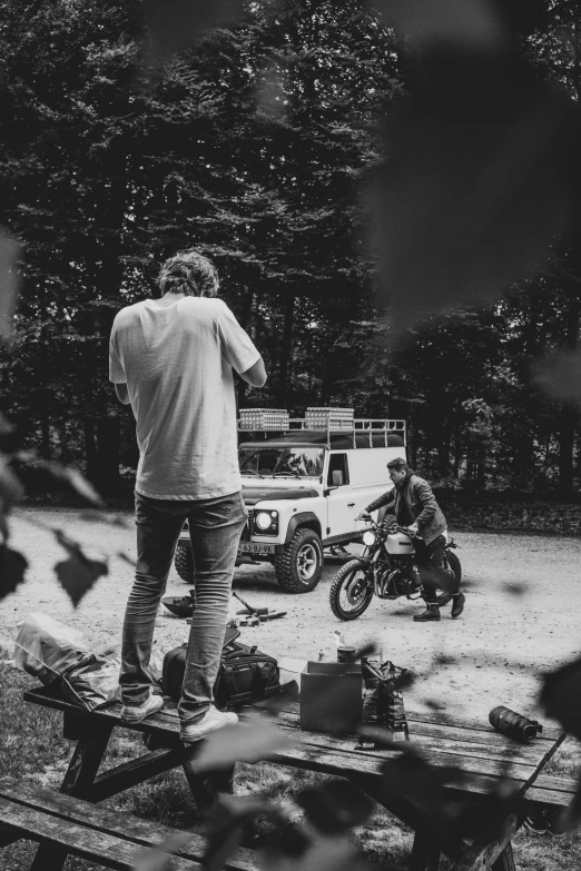 a group of people preparing food in the middle of a road