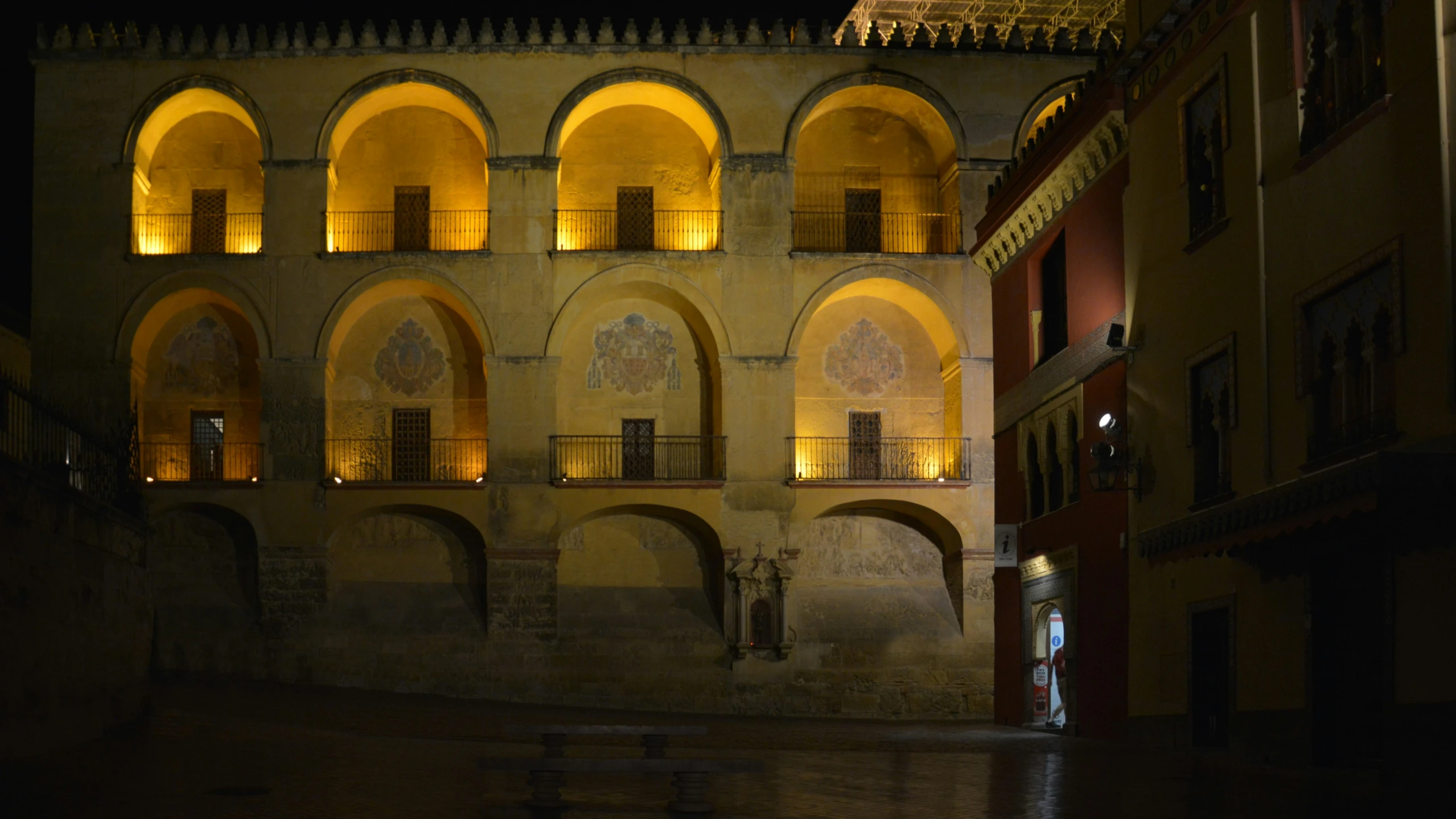 a building with arches at night lit up