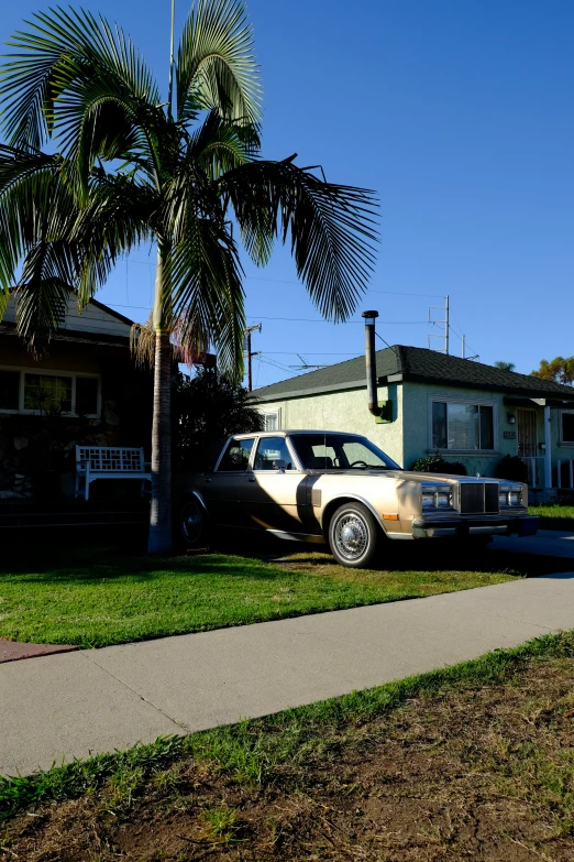 a couple of cars parked next to each other in front of houses