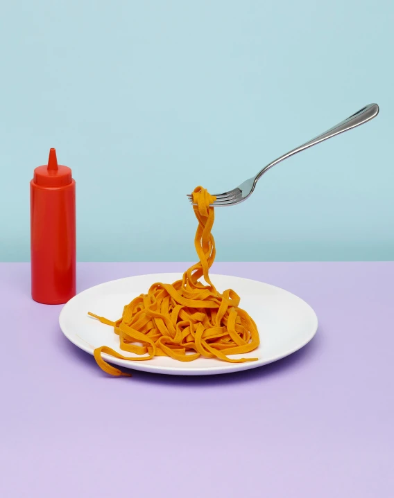 the plate with pasta sits next to a fork