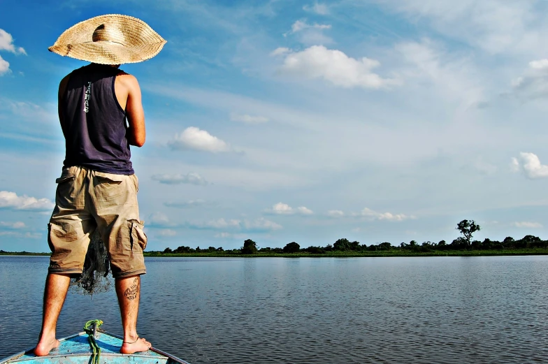 a man riding on top of a paddle board next to the ocean