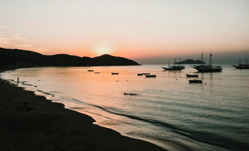 a beach with boats sitting on top of it