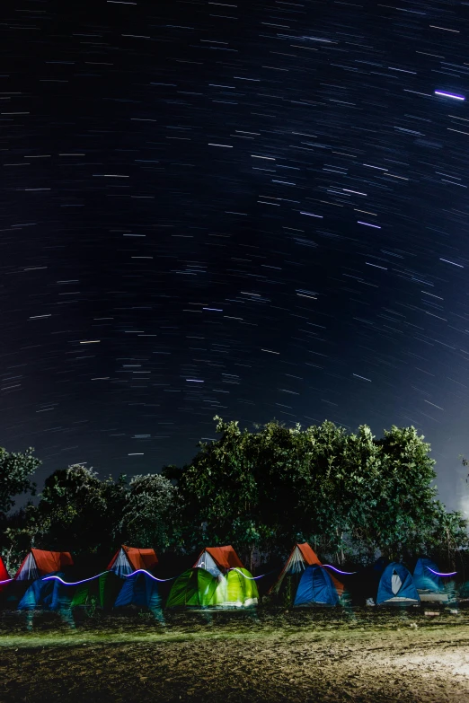 a grassy field under a night sky with stars