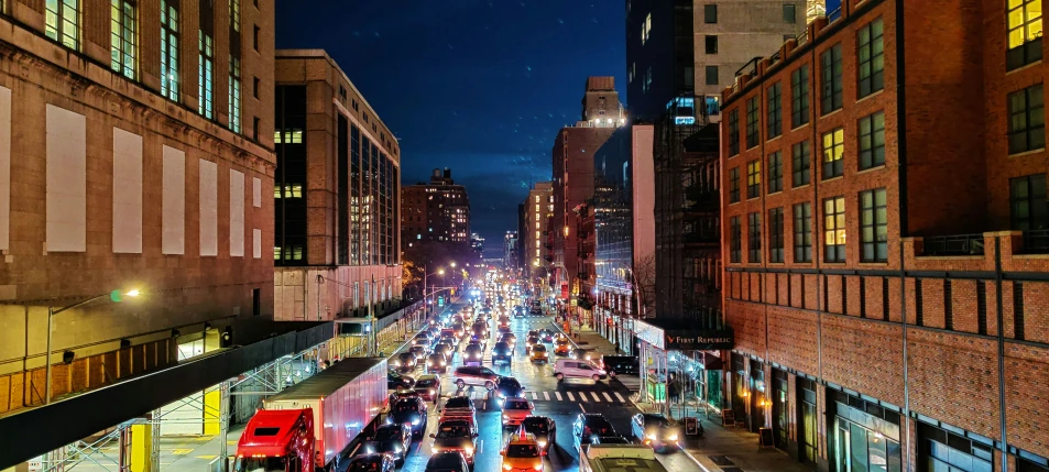 an aerial view of city at night with tall buildings