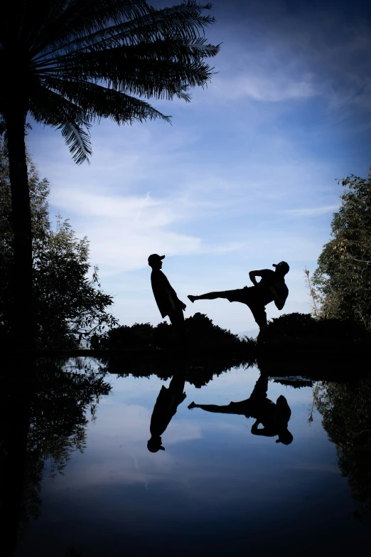 two people practicing karate moves on the water