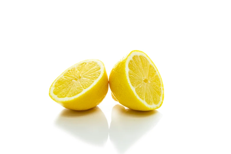 two lemons with slices cut in half