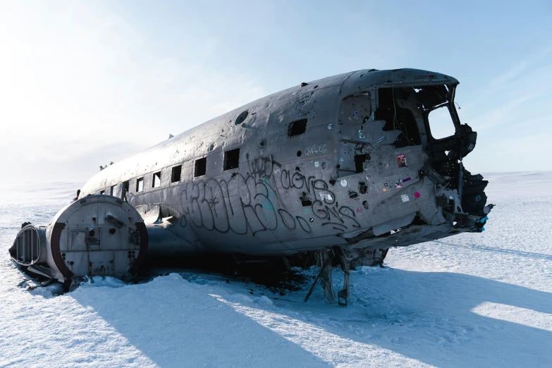 a run down old airplane covered in graffiti