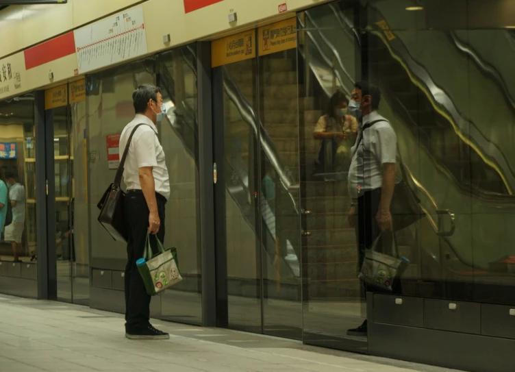 people standing in front of windows in a train station