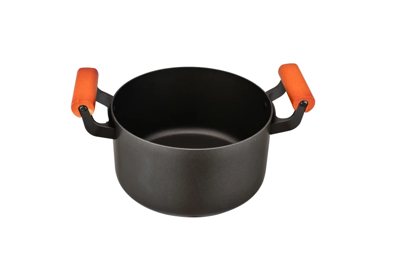 an iron pan with orange handles