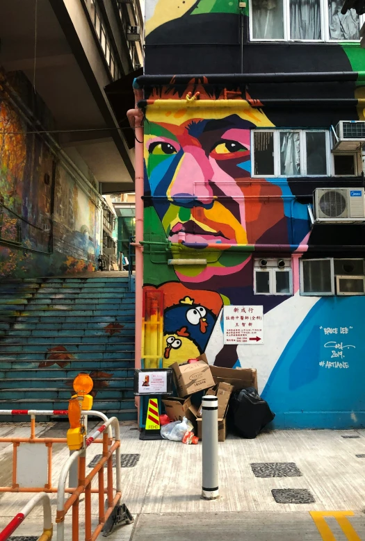 a colorful painted mural of a man on the side of a building