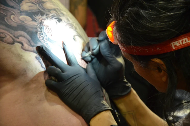 an arm tattoo artist working on his arm