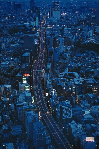 a street in a city at night with a large amount of traffic