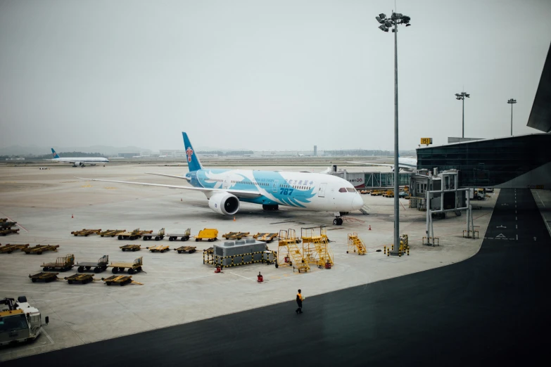 a white and blue jet parked on a tarmac