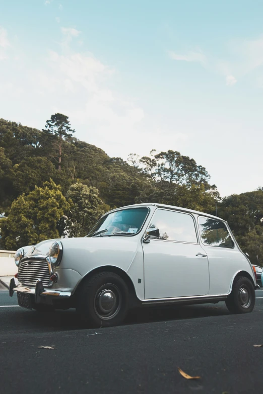 a white, well - kept car sits in the road