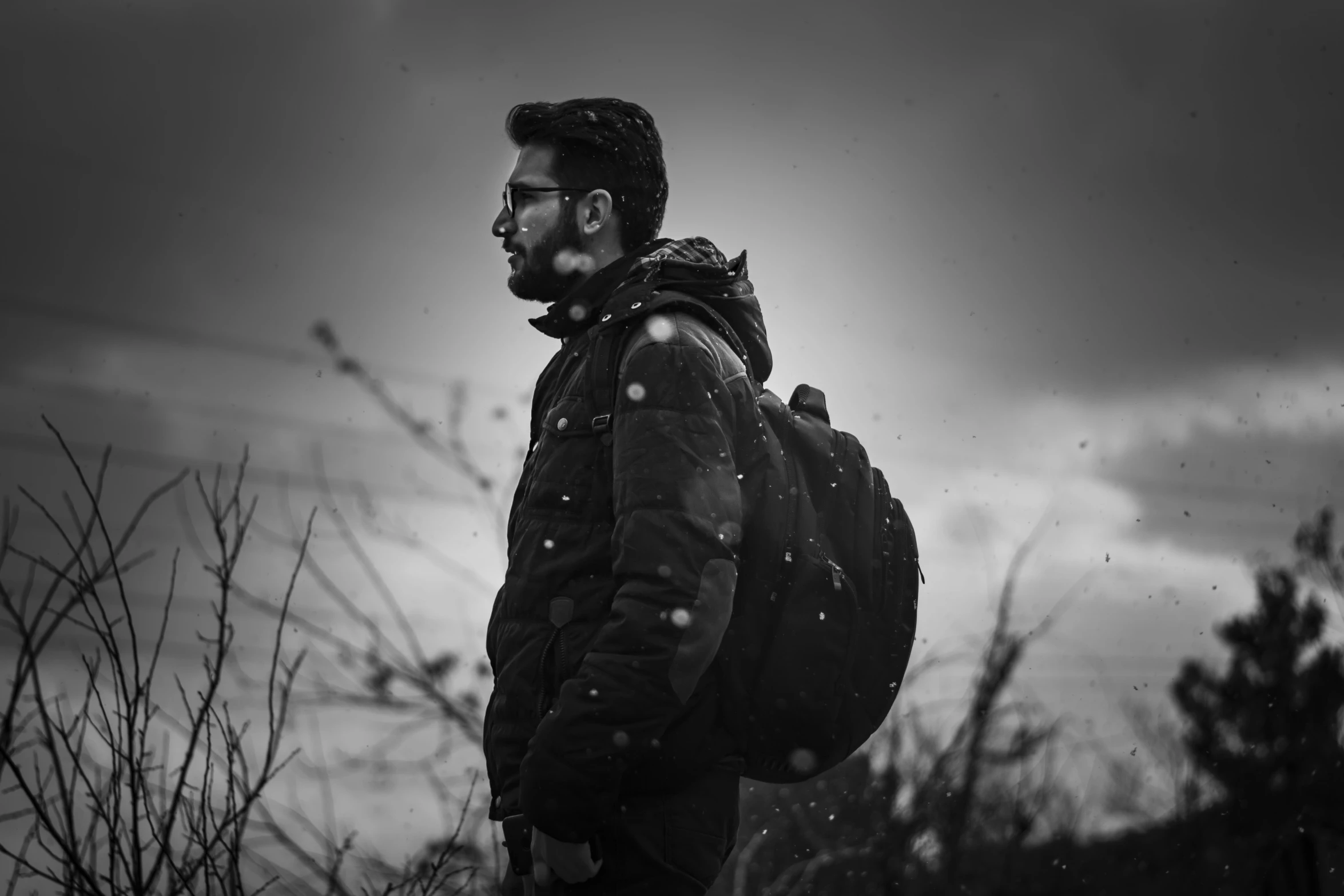 a man with a beard looking at the sky