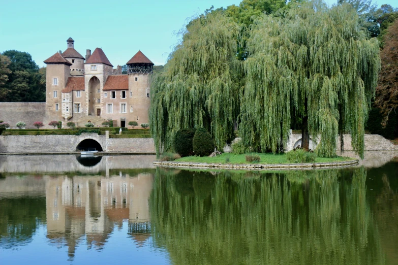 there is a large castle with a body of water in front of it