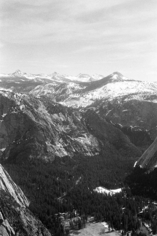 a mountain side with a very wide mountain range in the distance