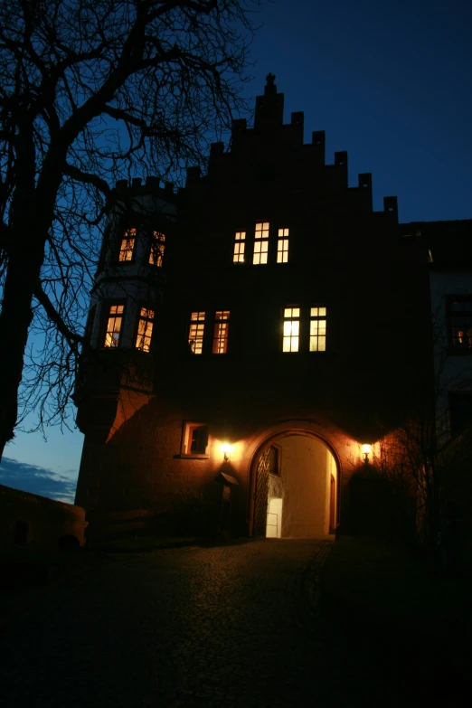 the night view of a very large building with many windows