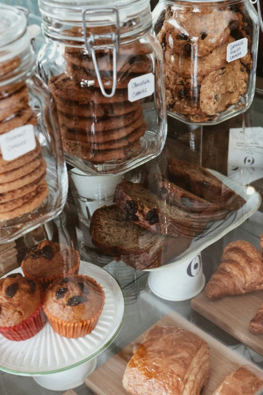 many pastries sit in glass jars with labels on them