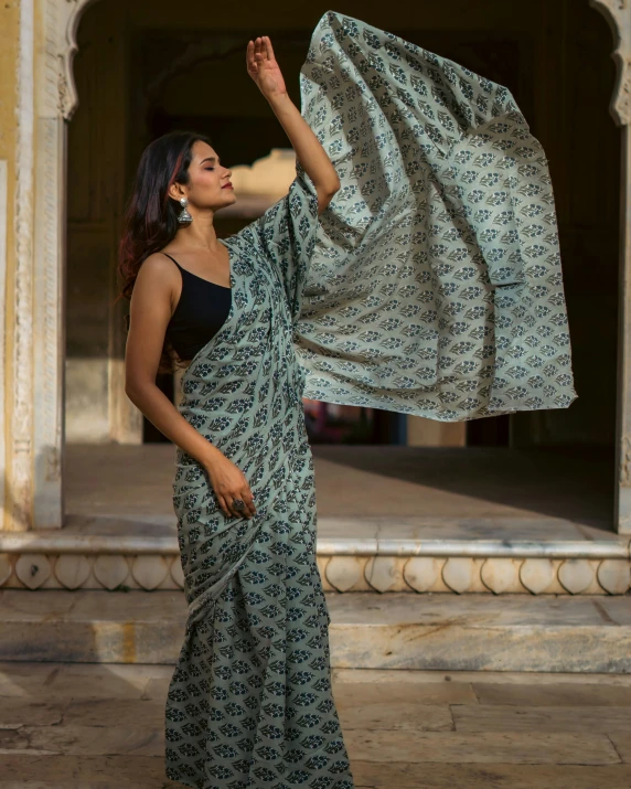 a lady is standing outside with a shawl