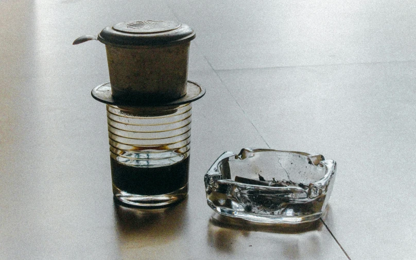 a plastic teacup and a glass on a table