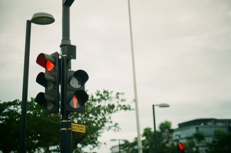 a traffic light stands in a large city street