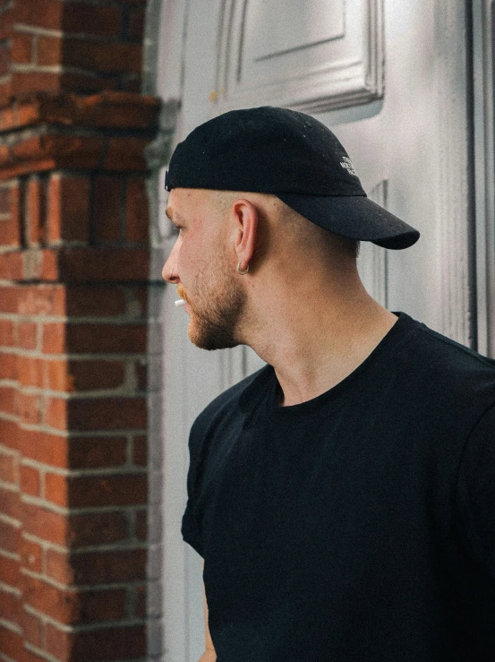 a man in black is standing in front of a door