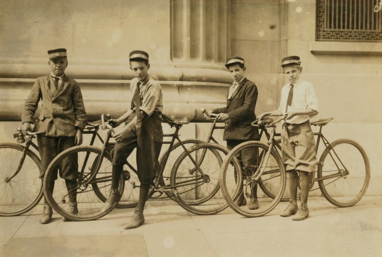 three men standing next to some bicycles in front of a building