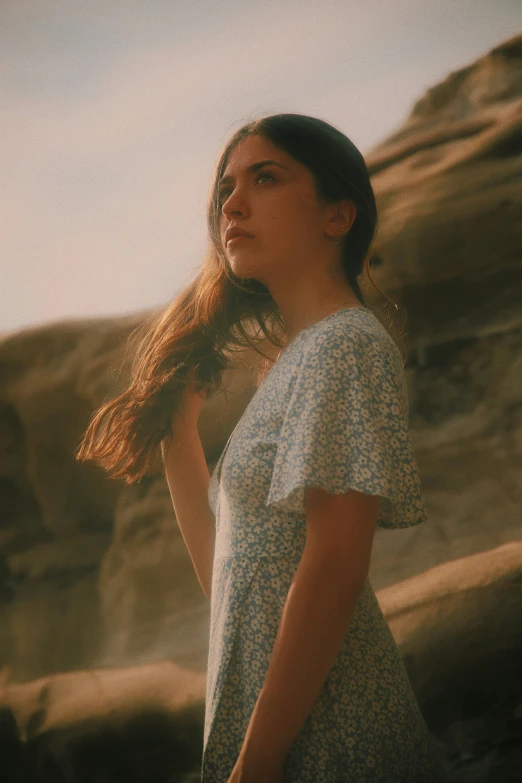 a woman with long hair looking up to the sky