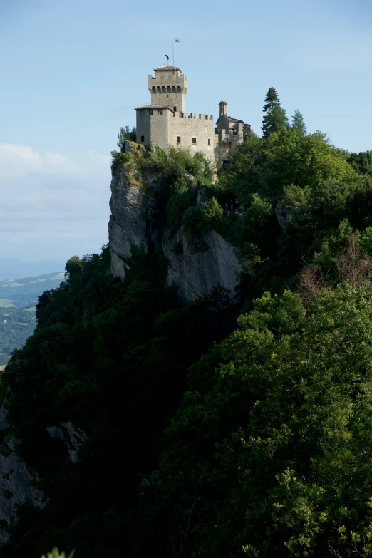 a building stands high on the side of a cliff