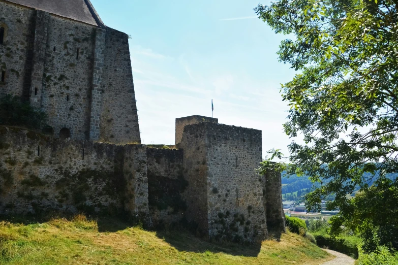 a tall brick building on top of a hill