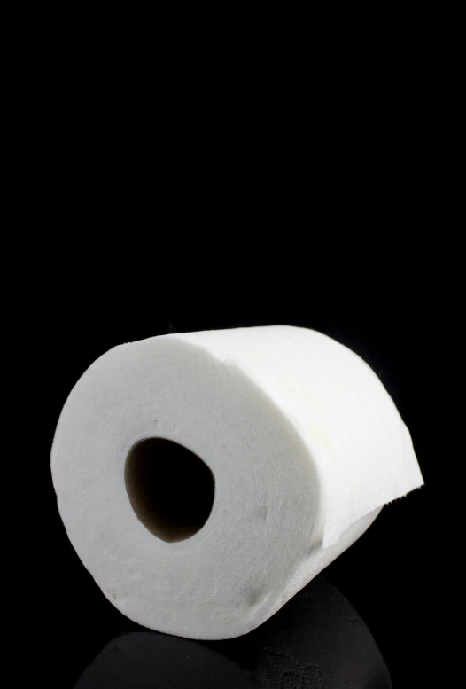 toilet paper rolled up on top of a black table